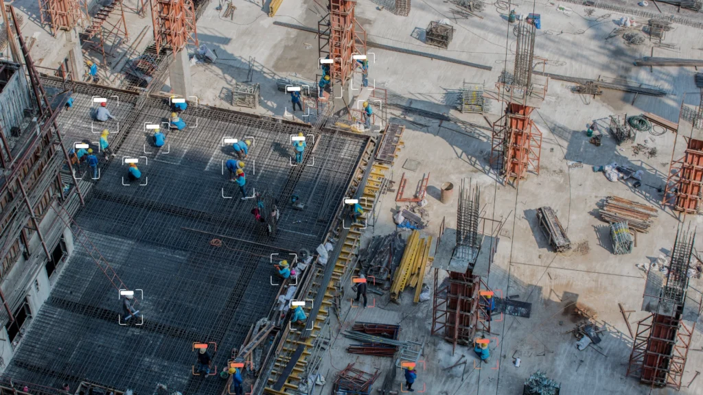 AI system scanning a construction site with workers to detect workplace safety violations.
